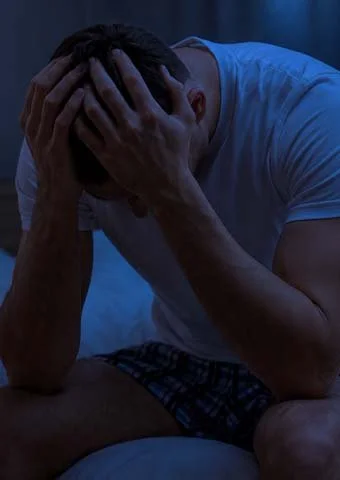 Person resting with head in hands, a reminder to check in with a professional when needed